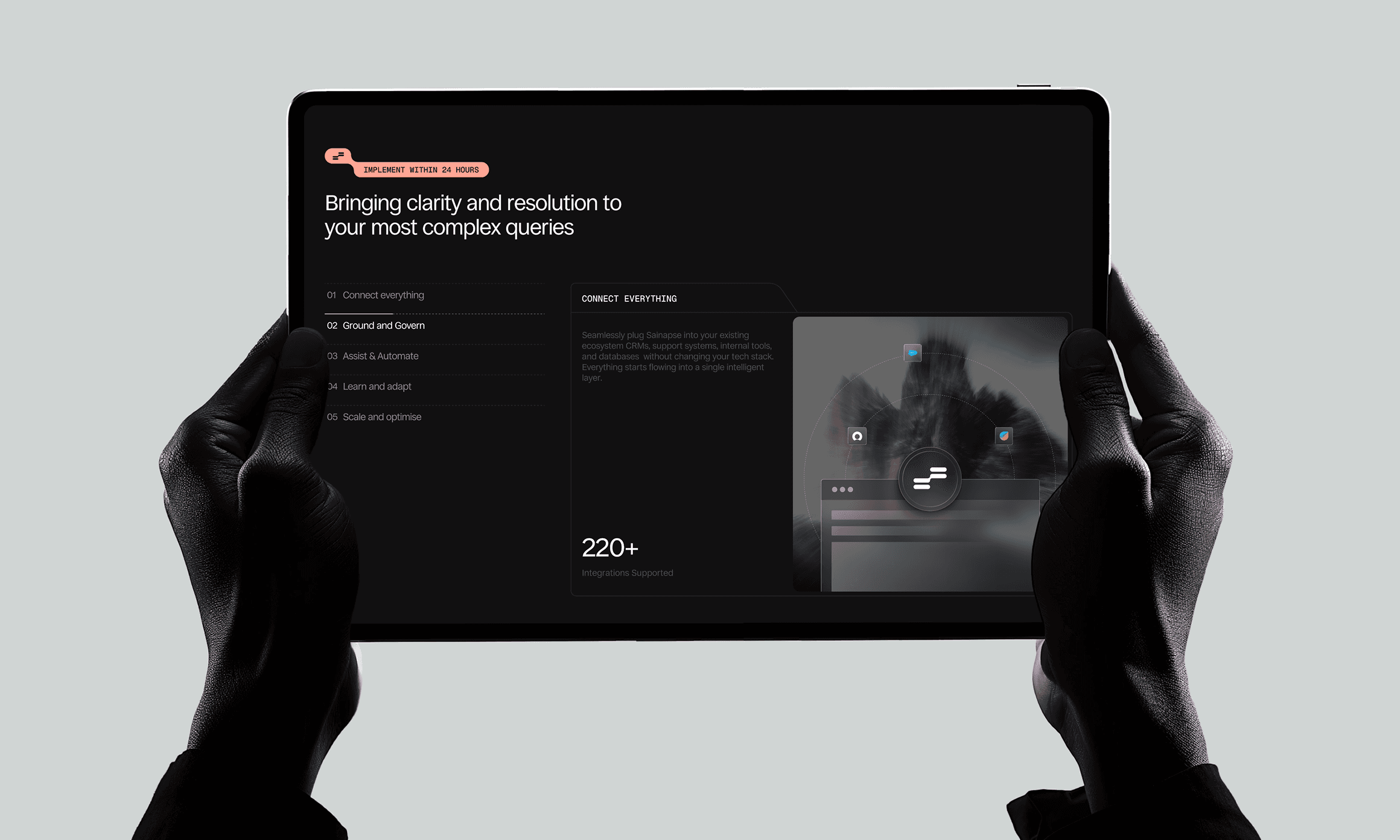 Sainapse dark product page on a tablet held in hands