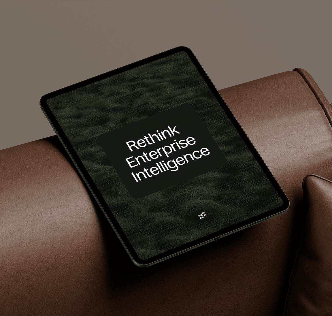 Sainapse Rethink Enterprise Intelligence tablet screen on a leather sofa